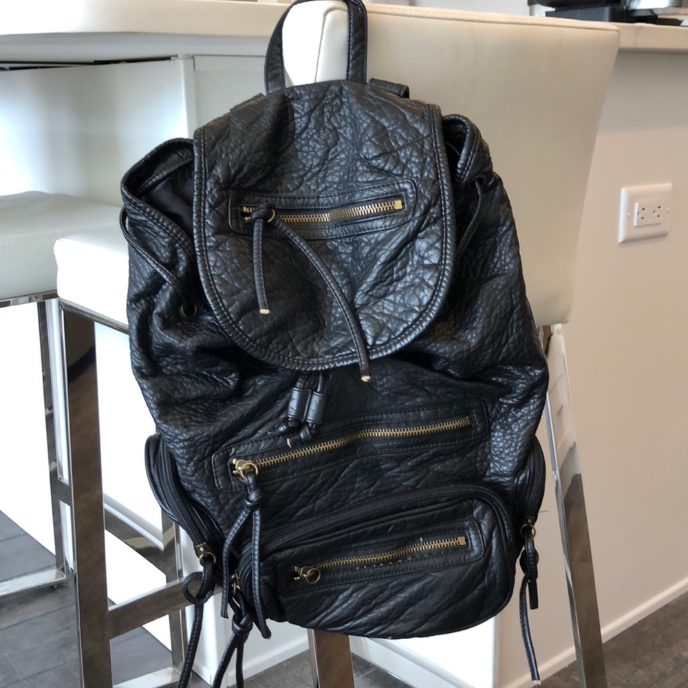 Black leather backpack with gold detailing